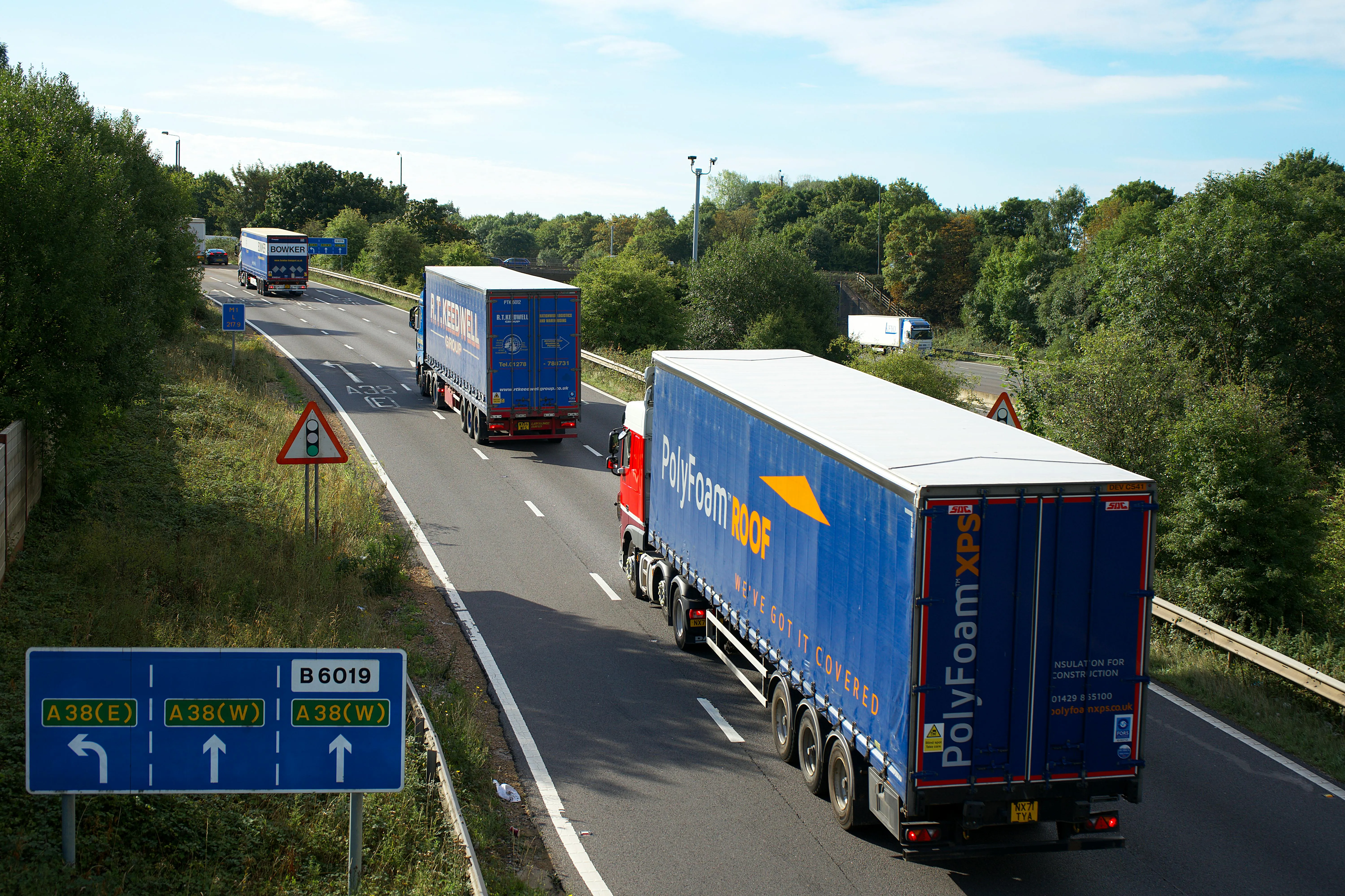 UK haulage lorries on an A-road, Tuffnells operated at this kind of scale across the UK.